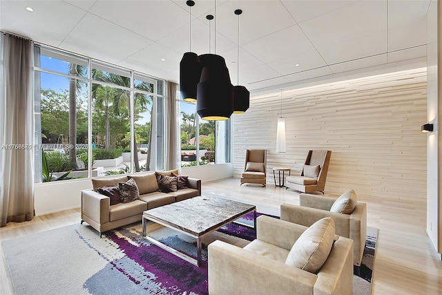 living room featuring recessed lighting, wood finished floors, and wooden walls