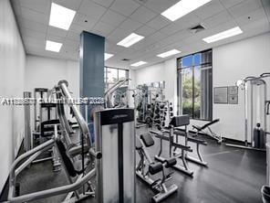 gym with a paneled ceiling