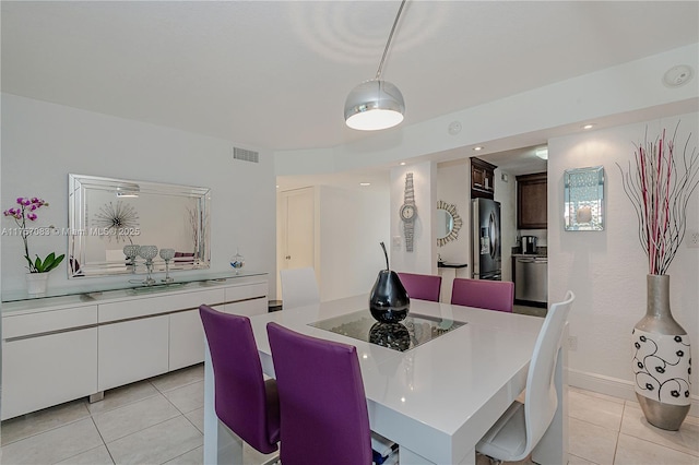 dining area with visible vents, baseboards, and light tile patterned flooring