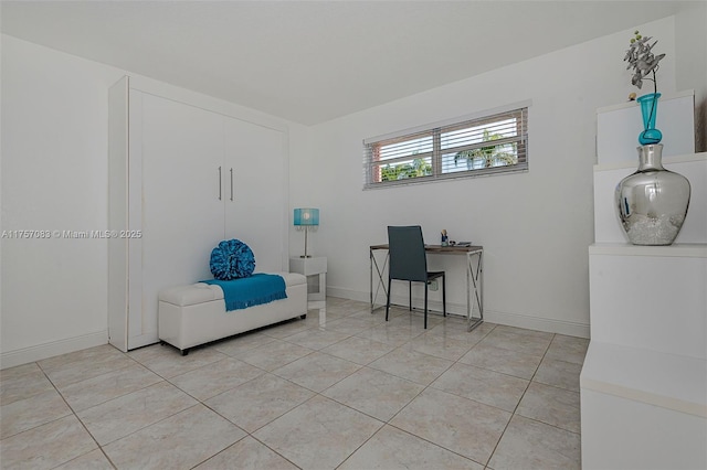 home office featuring baseboards and light tile patterned floors