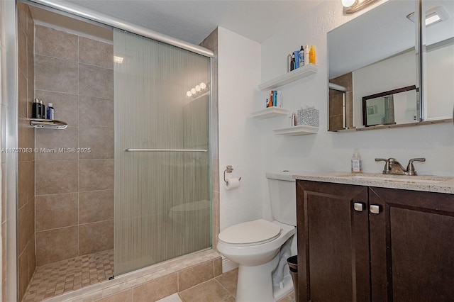 full bathroom with a stall shower, tile patterned flooring, vanity, and toilet