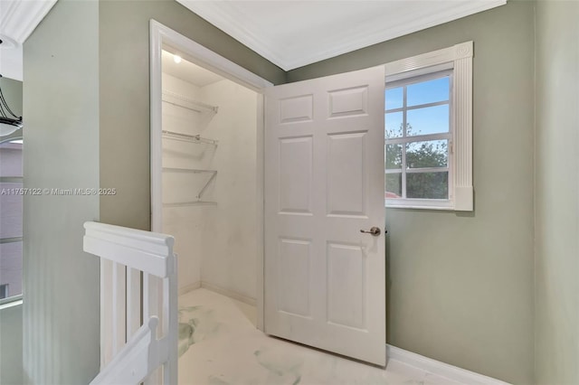 interior space featuring ornamental molding and baseboards