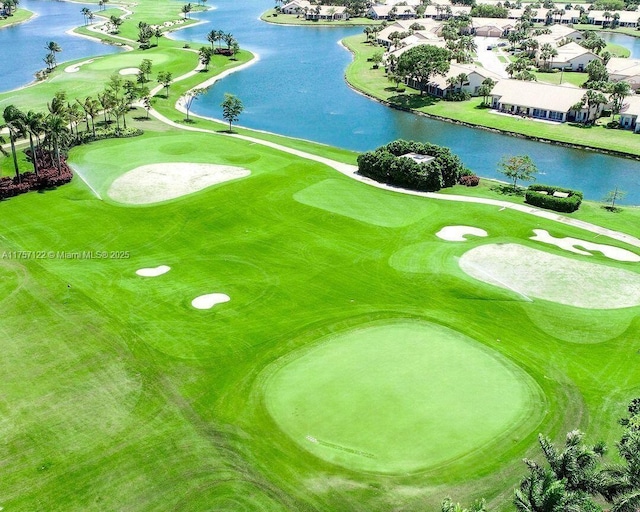 drone / aerial view with a residential view, a water view, and golf course view