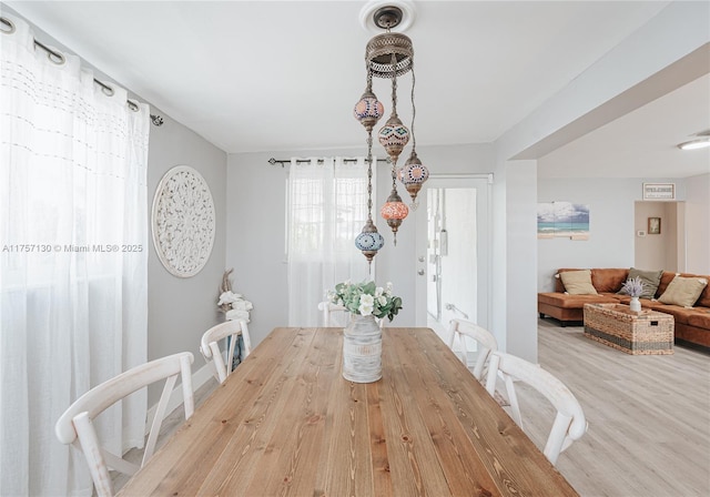 dining space with wood finished floors