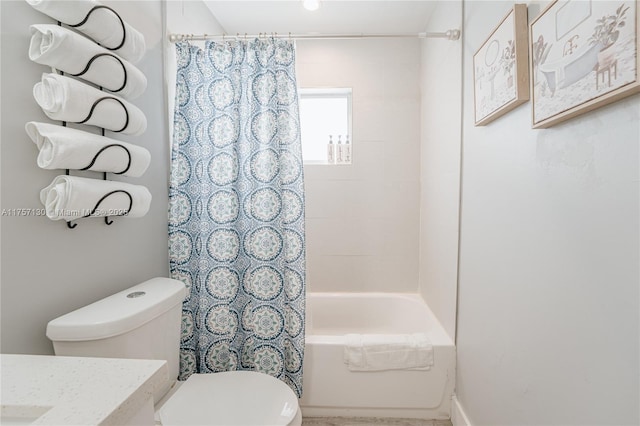 full bath featuring vanity, shower / bath combo with shower curtain, and toilet