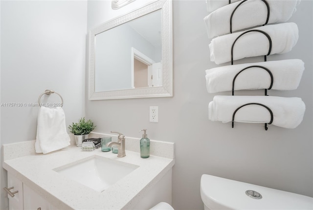 half bathroom with toilet and vanity