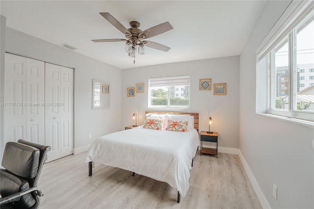 bedroom featuring wood finished floors, visible vents, and baseboards