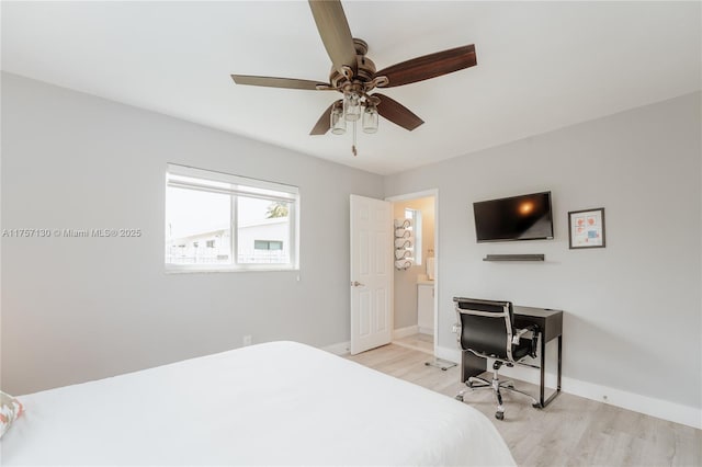 bedroom with light wood finished floors, baseboards, and a ceiling fan