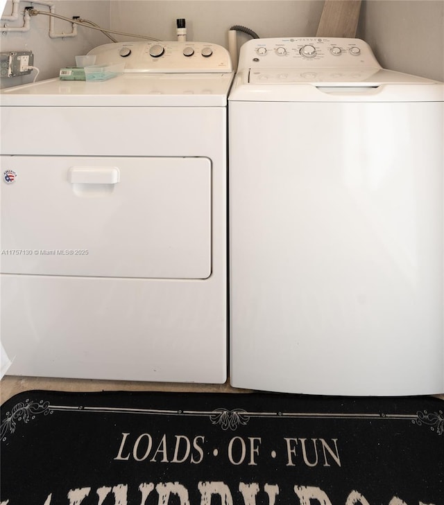 clothes washing area with washing machine and dryer and laundry area