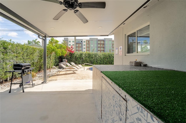 view of patio featuring a grill and a ceiling fan