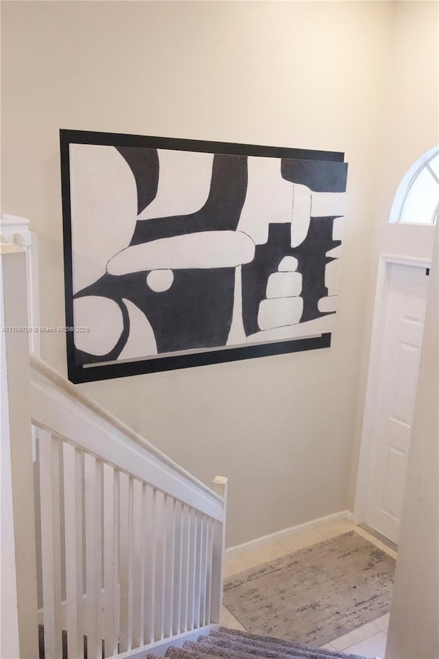 foyer featuring baseboards and tile patterned floors