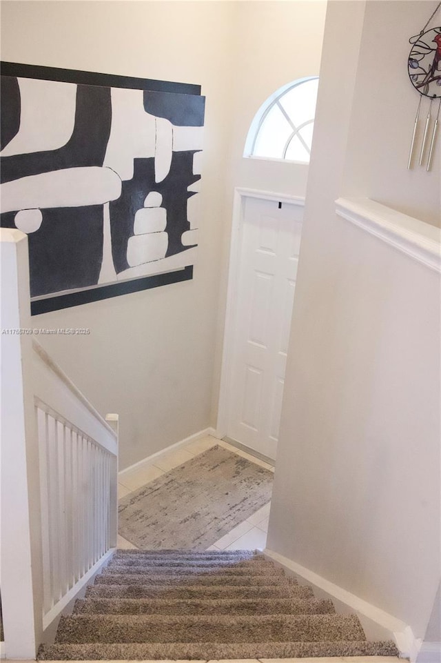 foyer with baseboards and tile patterned floors