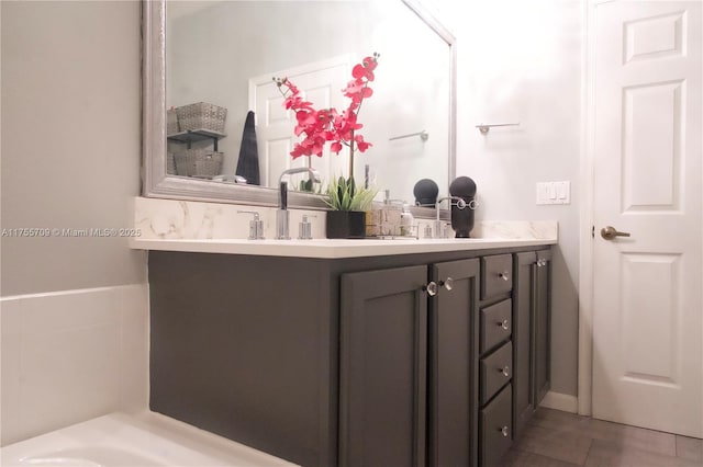 full bath featuring a sink, double vanity, and tile patterned flooring