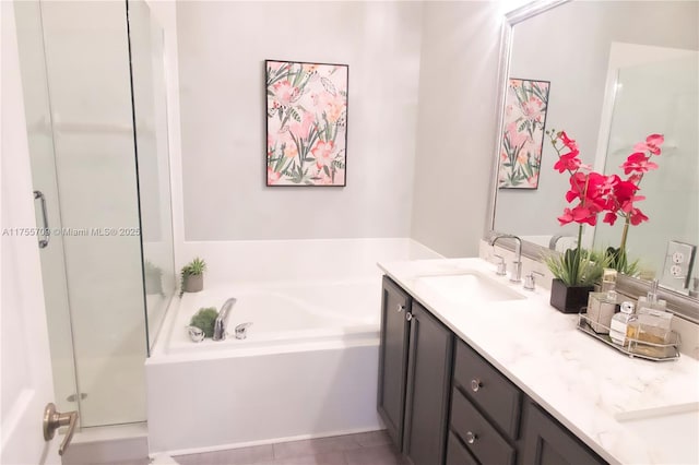 bathroom featuring vanity, a shower stall, and a bath