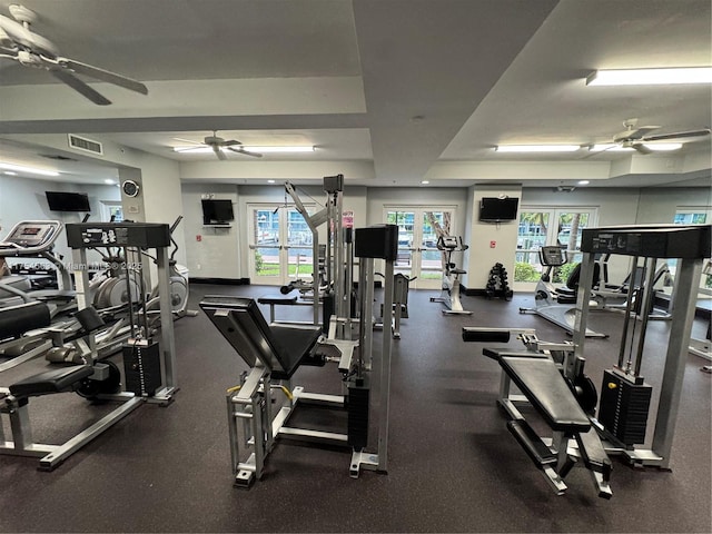 workout area featuring baseboards, visible vents, a raised ceiling, a ceiling fan, and french doors