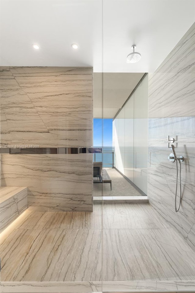 full bath featuring a marble finish shower