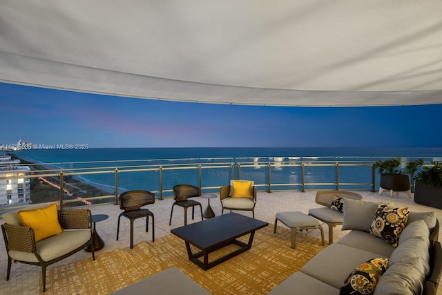 balcony featuring a water view and an outdoor hangout area