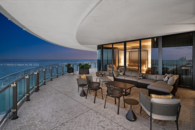 view of patio featuring a water view and an outdoor living space