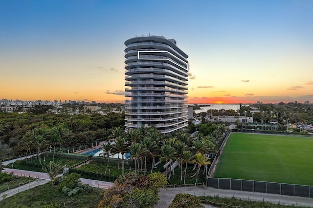 property at dusk featuring a view of city