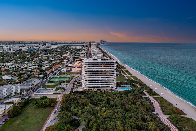 birds eye view of property with a view of the beach, a water view, and a view of city