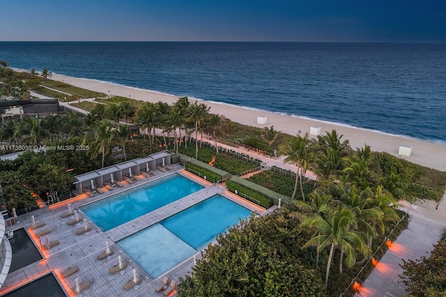 drone / aerial view with a water view and a beach view