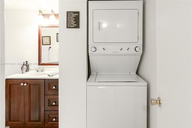 clothes washing area featuring laundry area, a sink, and stacked washer and clothes dryer