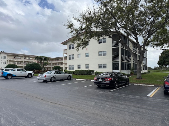 view of property featuring uncovered parking