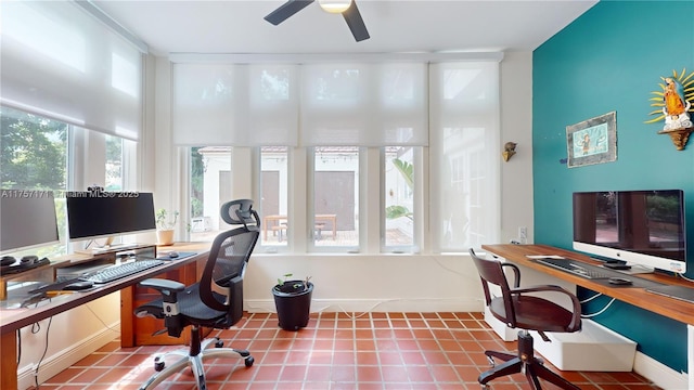 tiled home office featuring ceiling fan and baseboards