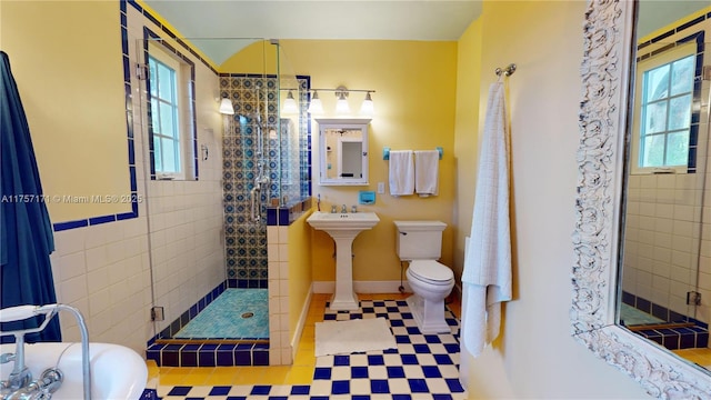 full bath with a stall shower, baseboards, toilet, a bathing tub, and a sink