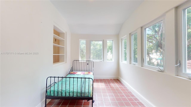 sunroom / solarium featuring vaulted ceiling