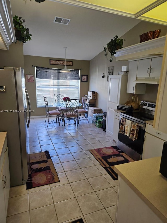 kitchen with under cabinet range hood, light tile patterned floors, visible vents, and stainless steel appliances