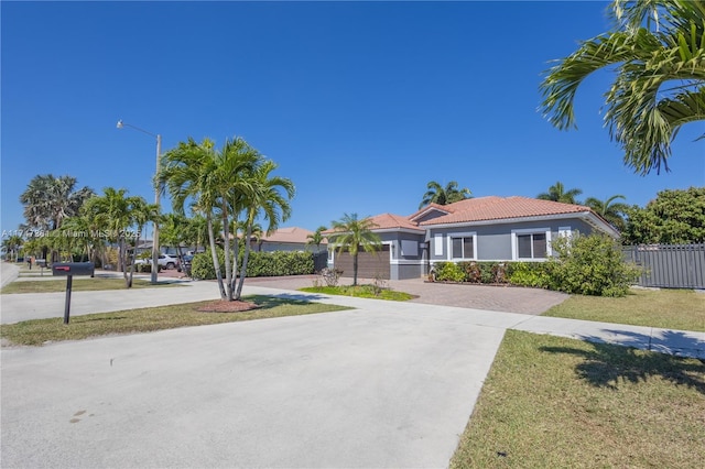 15333 SW 184th St, Miami, FL 33187 - view of front of home with a tile roof, fence, concrete driveway, stucco siding, and a front yard