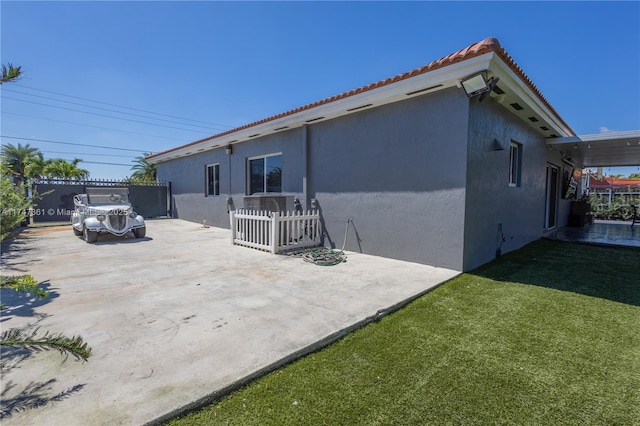 15333 SW 184th St, Miami, FL 33187 - back of house with a tile roof, a patio, stucco siding, a lawn, and fence