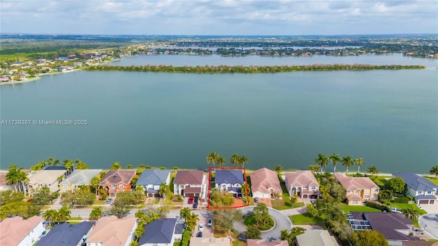 drone / aerial view featuring a residential view and a water view