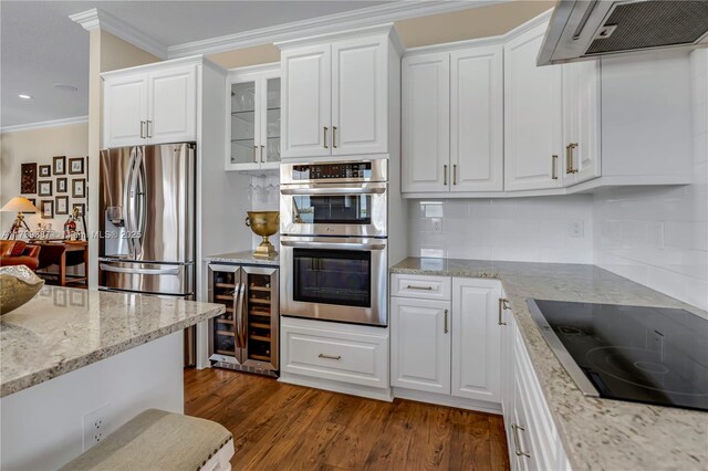 19239 SW 54th St, Miramar, FL 33029 - kitchen with wine cooler, appliances with stainless steel finishes, extractor fan, ornamental molding, and white cabinetry