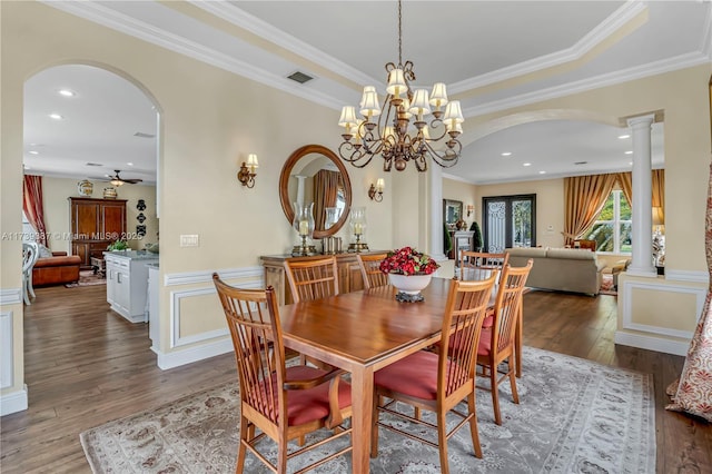 dining area with visible vents, crown molding, hardwood / wood-style flooring, arched walkways, and ornate columns