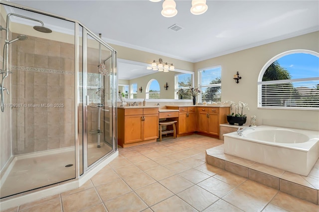 full bath featuring a stall shower, vanity, a garden tub, and ornamental molding