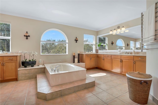 bathroom featuring a bath, tile patterned floors, vanity, and crown molding