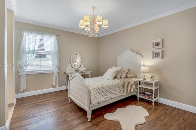 bedroom with crown molding, wood finished floors, baseboards, and a chandelier