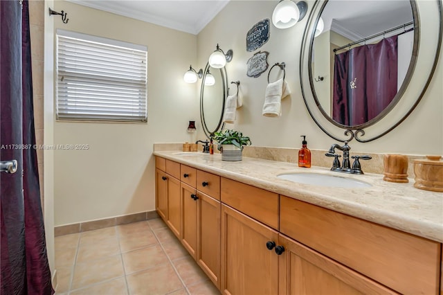 full bath with tile patterned flooring, crown molding, baseboards, double vanity, and a sink