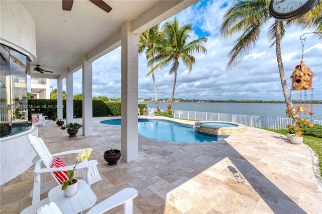 19239 SW 54th St, Miramar, FL 33029 - view of swimming pool with ceiling fan, a pool with connected hot tub, a water view, a fenced backyard, and a patio area