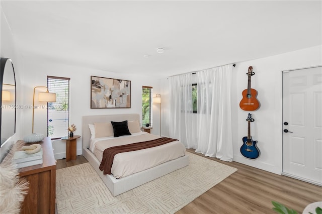 bedroom with wood finished floors and baseboards