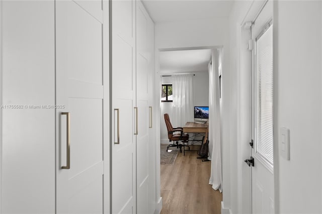 hallway with light wood-type flooring