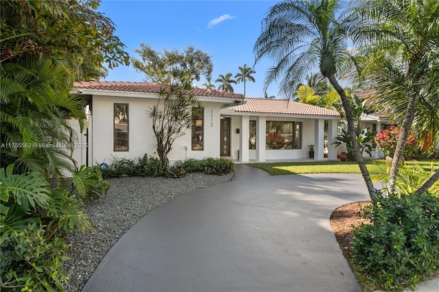 mediterranean / spanish-style home featuring a tile roof and stucco siding