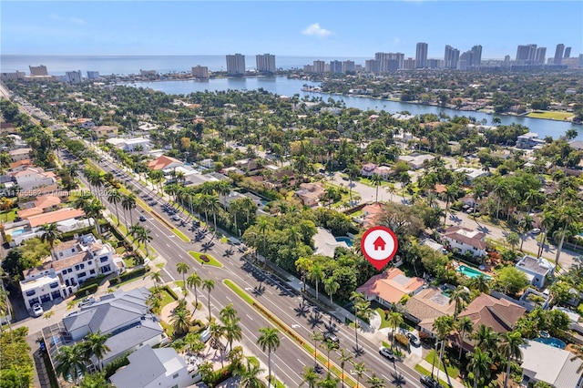 drone / aerial view featuring a water view and a view of city