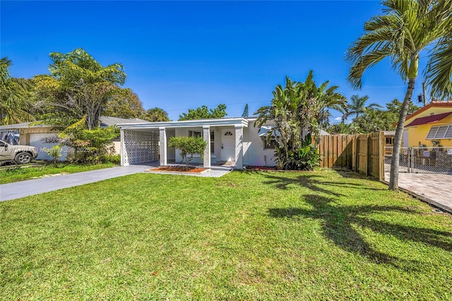 view of front of house featuring driveway, a front yard, fence, and stucco siding