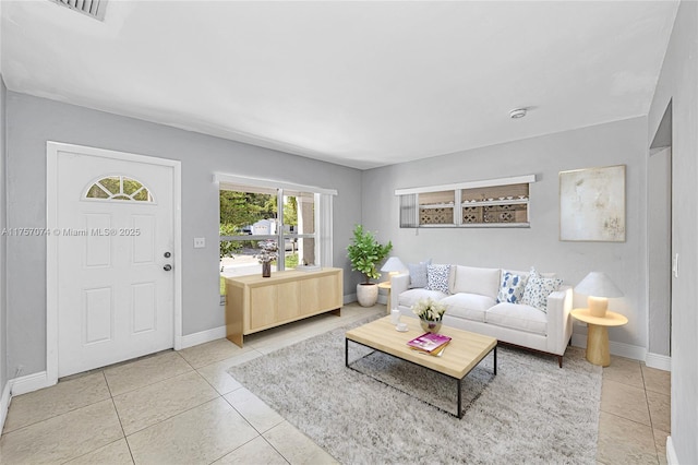 tiled living area featuring visible vents and baseboards