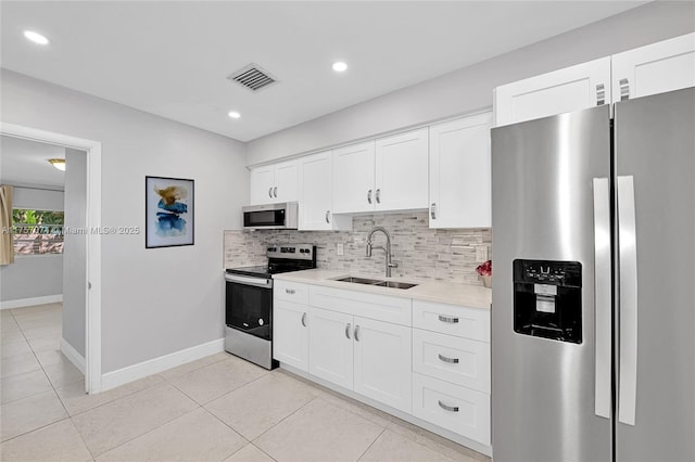 5248 N Andrews Ave, Oakland Park, FL 33309 - kitchen featuring stainless steel appliances, tasteful backsplash, light countertops, visible vents, and a sink