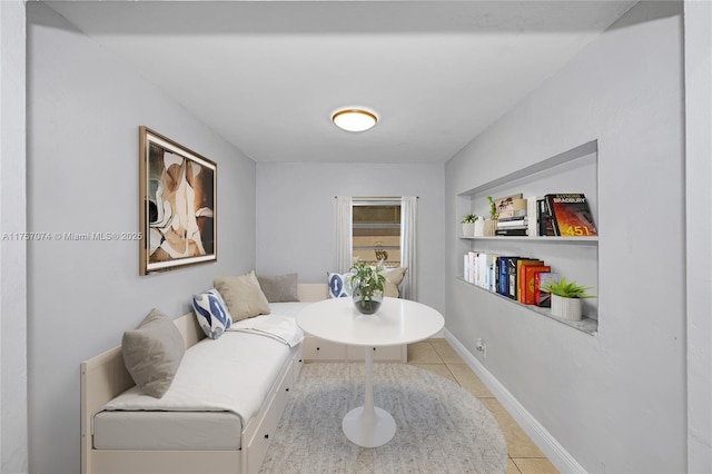 living area featuring tile patterned flooring and baseboards