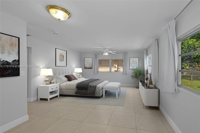 bedroom with light tile patterned floors, multiple windows, and baseboards